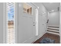 Bright foyer featuring white paneled doors, natural light, and access to the staircase at 649 Pendergrass Rd, Sanford, NC 27330