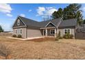 Attractive single-story home featuring complementary siding colors and a well manicured lawn at 649 Pendergrass Rd, Sanford, NC 27330