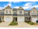Charming townhouse with neutral siding, attached garage, and well-maintained landscaping at 7246 Aquinas Avenue Ave, Raleigh, NC 27617