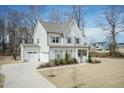 Inviting two-story home with an attached garage and pristine lawn, ideal for families at 76 Freewill Pl, Raleigh, NC 27603