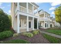 View of home's exterior featuring a covered front porch, columns, and maintained front yard at 7732 Acc Blvd, Raleigh, NC 27617