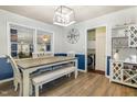 Eat-in dining room with blue accent wall, view of laundry area, and wooden styled laminate floors at 78 Eagle Rd, Coats, NC 27521