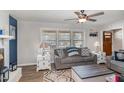 Cozy living room features hardwood floors, neutral paint, ceiling fan, and access to a wooden front door at 78 Eagle Rd, Coats, NC 27521
