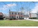 Attractive two-story brick home with black shutters and a spacious two-car garage at 810 Warwick Ct, Burlington, NC 27215