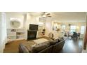 Open living room features a fireplace with built-ins and views of the kitchen at 100 E Delafield Ave, Durham, NC 27704