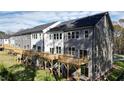 Townhome rear view showing wood decks, multiple windows, and well-maintained lawn at 1013 Regalia Rd # 28, Durham, NC 27713