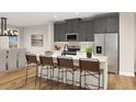 Modern kitchen with gray cabinets, stainless steel appliances, and a center island with seating at 1013 Regalia Rd # 28, Durham, NC 27713