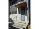Welcoming front entrance with a modern door, sleek hardware, and manicured greenery at 103 Inara Ct, Carrboro, NC 27510