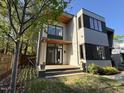 Contemporary home with a wooden porch, large windows, and sleek design, surrounded by lush greenery at 103 Inara Ct, Carrboro, NC 27510