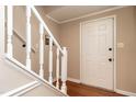Bright entryway with hardwood floors and a white staircase leading to the upper level at 1036 Whetstone Ct, Raleigh, NC 27615