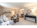 Bright living room with plush carpeting, stylish furnishings, and neutral color palette at 1036 Whetstone Ct, Raleigh, NC 27615