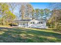 Single-story home has a well maintained lawn and white painted brick exterior walls at 109 Hardee St, Clayton, NC 27520