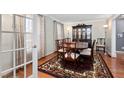 Elegant dining room featuring hardwood floors, a china cabinet, and a large table for entertaining at 1201 Deerfield Dr, Cary, NC 27511