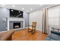 Comfortable living room with a cozy fireplace, hardwood floors, and ample natural light at 1201 Deerfield Dr, Cary, NC 27511
