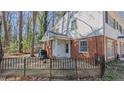 Side view of a two-story brick home with a fenced yard and mature trees at 126 Radcliff Cir, Durham, NC 27713