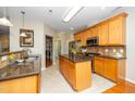 Spacious kitchen featuring wooden cabinets, granite countertops, a central island, and stainless appliances at 126 Star Flower Ct, Apex, NC 27539