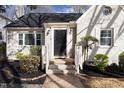 Charming home featuring classic brickwork, complemented by well-manicured shrubs and brick steps at 1304 N Duke St, Durham, NC 27701