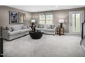 Relaxing living room showcasing plush sofas, neutral decor, and natural light from a large window at 1364 Chowan Ave, Durham, NC 27713
