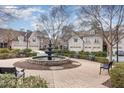 Attractive community featuring a water fountain and manicured landscaping, benches, and well maintained buildings at 164 Arabella Ct, Cary, NC 27518
