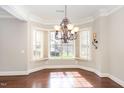 Elegant dining area with hardwood floors, large windows, and decorative lighting, showcasing a bright and open space at 164 Arabella Ct, Cary, NC 27518