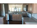Bright kitchen featuring stainless steel appliances, wood cabinets, and eat-in dining area at 1906 Hawfields Crossing Ln, Mebane, NC 27302