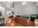 Spacious living room with hardwood floors, a fireplace, high ceilings, and a loft overlook at 1928 Jupiter Hills Ct, Raleigh, NC 27604