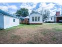 View of the back of the home with wood deck and bright sun room at 229 Short St, Wendell, NC 27591