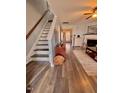 Welcoming entryway showcasing wood flooring, a staircase, and a glimpse into the comfortable living room at 2323 Turtle Point Dr, Raleigh, NC 27604