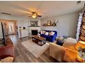 Inviting living room featuring a fireplace, ceiling fan, and a cozy seating arrangement with stylish decor at 2323 Turtle Point Dr, Raleigh, NC 27604