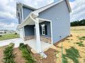 Side view of a two-story home, showcasing its well-maintained siding and charming architectural details at 253 Deodora Ln, Cameron, NC 28326
