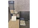 Samples of flooring, carpet, countertops, and cabinet finishes in coordinating colors for the new home at 253 Deodora Ln, Cameron, NC 28326