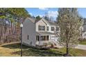 Charming two-story home with a well-maintained lawn, tree, and an inviting front porch at 264 Farrington Dr, Clayton, NC 27520