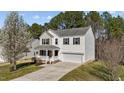Charming two-story home with a well-maintained lawn and an inviting front porch at 264 Farrington Dr, Clayton, NC 27520