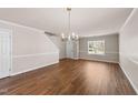 Bright living room with hardwood floors, chandelier, and neutral paint scheme at 264 Farrington Dr, Clayton, NC 27520