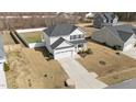 Aerial shot of a two-story home featuring a driveway and white picket fence at 277 Martins Mill Ct, Wendell, NC 27591