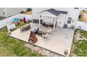 Aerial view of the backyard with covered porch, outdoor seating, and a fire pit perfect for entertaining at 277 Martins Mill Ct, Wendell, NC 27591