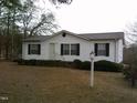 Inviting home featuring mature landscaping, a birdhouse and a welcoming entryway at 3211 Kipling Rd, Fuquay Varina, NC 27526