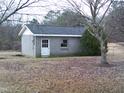 Exterior view of detached block building with a single window and entry door at 3211 Kipling Rd, Fuquay Varina, NC 27526