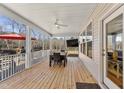 Covered back patio with an outdoor dining area, ceiling fan, and view of the backyard at 33 Song Breeze Cir, Angier, NC 27501