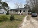 A well maintained single-story home with vinyl siding and a front yard with mature trees at 402 Todd Hill Dr, Wendell, NC 27591