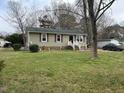 Charming single-story home with green siding, maroon shutters, and a well-maintained lawn at 402 Todd Hill Dr, Wendell, NC 27591