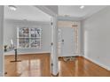 Bright home entryway with hardwood floors, white trim and a clear view to the office at 413 Westfalen Dr, Cary, NC 27519