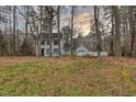 Two-story home with light gray siding, dark shutters, and a detached garage at 48 Margaret Pl, Chapel Hill, NC 27516