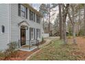 Exterior of a home with dark shutters, black railings, and a quaint stone walkway at 48 Margaret Pl, Chapel Hill, NC 27516