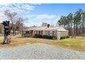 Well-kept single-Gathering house with a metal roof, a screened-in porch, and a gravel driveway at 492 Pixley Pritchard Rd, Timberlake, NC 27583
