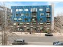 Modern building with a blue facade, featuring multiple windows and private balconies at 515 N Mangum St # 14, Durham, NC 27701