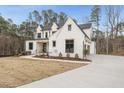 Beautiful home showcasing its white brick facade, black trim, and attached garage at 5213 Bent Leaf Dr, Raleigh, NC 27606