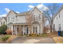 Beautiful exterior elevation of a charming two-story townhome featuring a welcoming front porch at 5321 Cog Hill Ct, Raleigh, NC 27604
