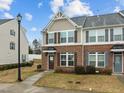 Attractive townhouse with classic brickwork, complementing siding, and a well-maintained front yard at 533 Berry Chase Way, Cary, NC 27519
