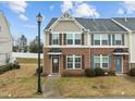 Inviting townhouse with brick and siding, a front lawn, and detailed trim, perfect for comfortable living at 533 Berry Chase Way, Cary, NC 27519